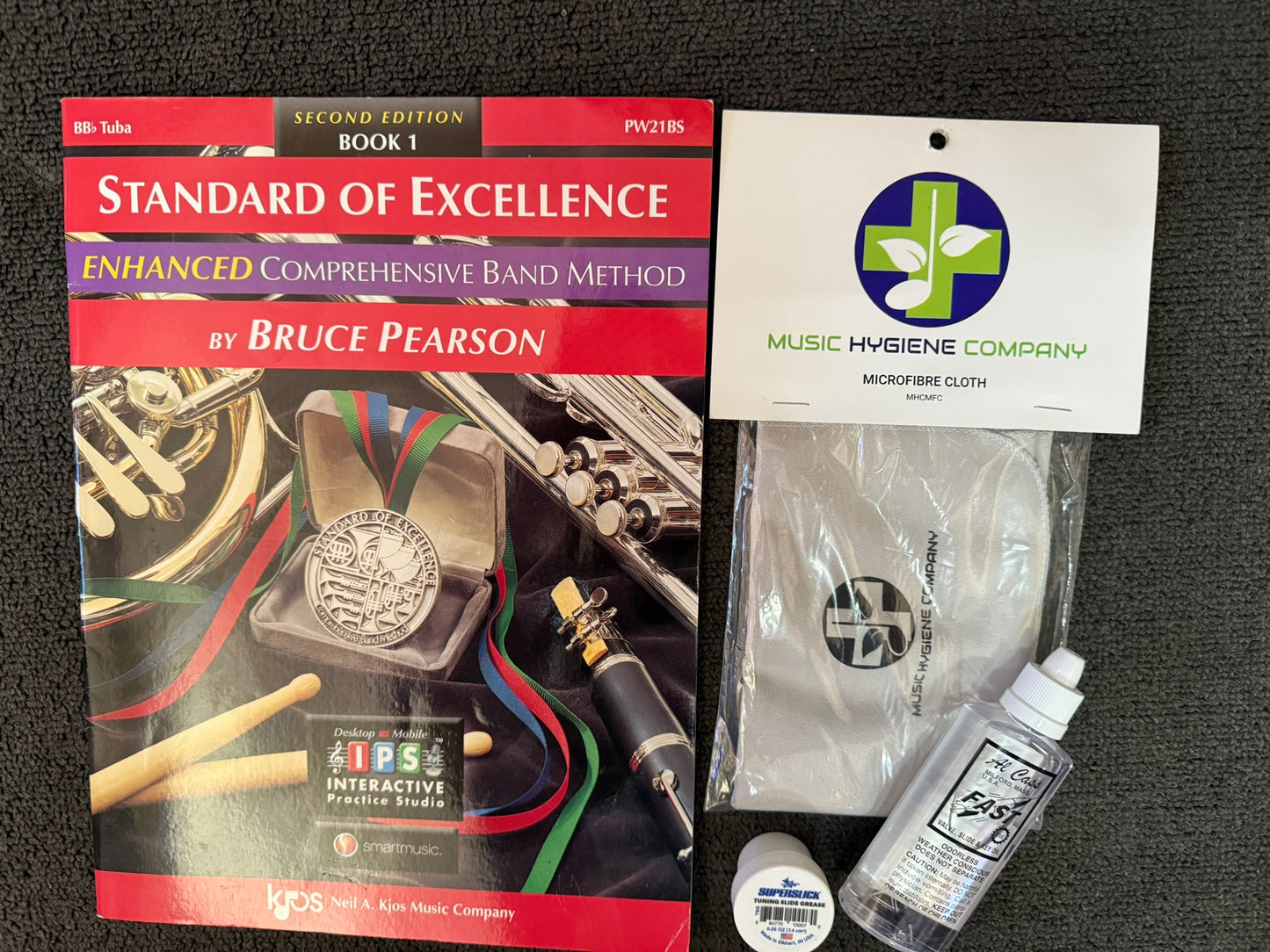 Tuba student bundle with book, grease, oil, and cleaning cloth.