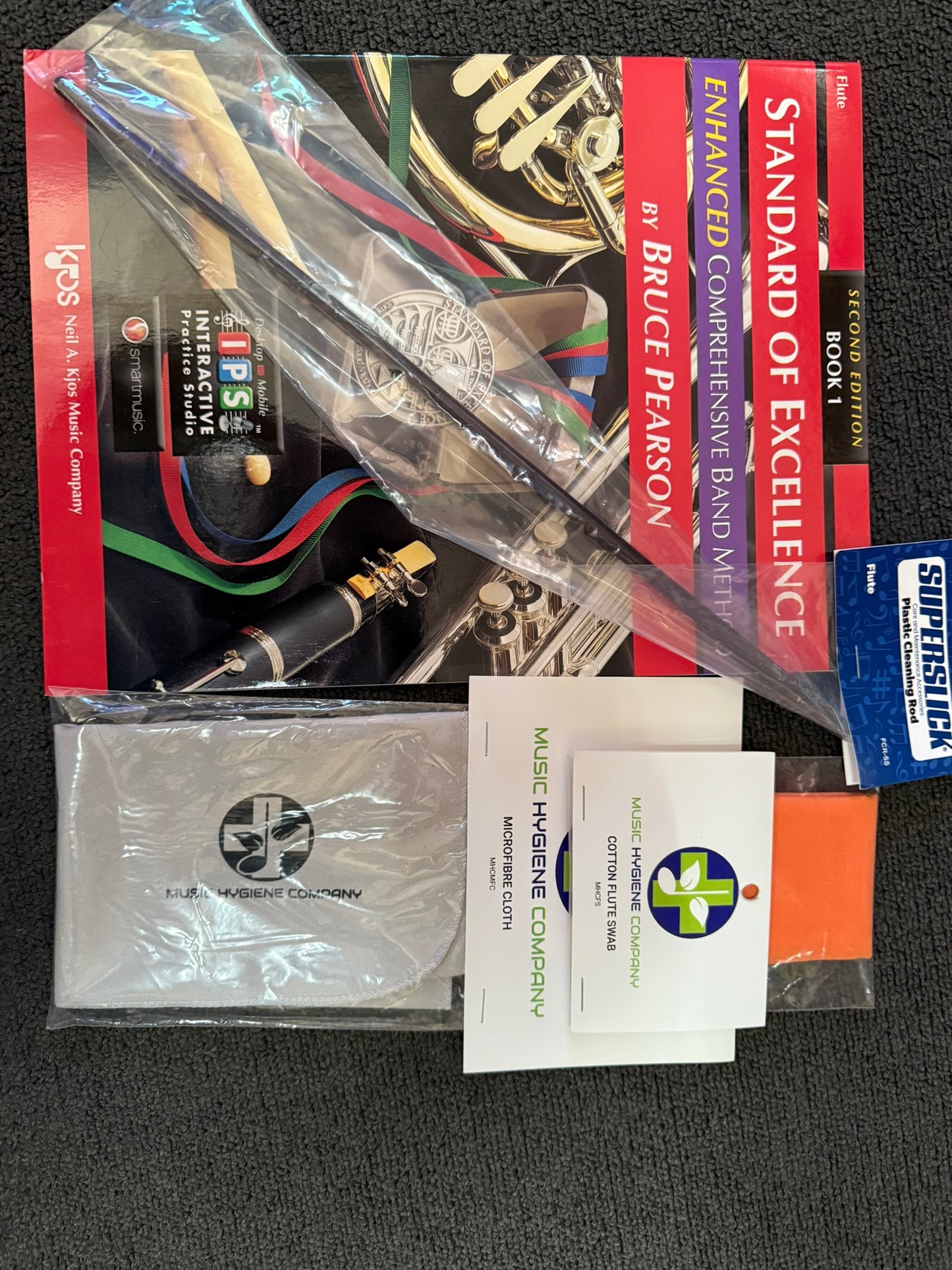 Flute student bundle with book, cleaning rod, and swabs.