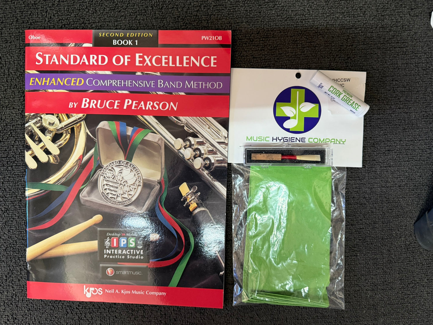 Oboe Deluxe Student Bundle with book, reed, cork grease, and cleaning cloth.