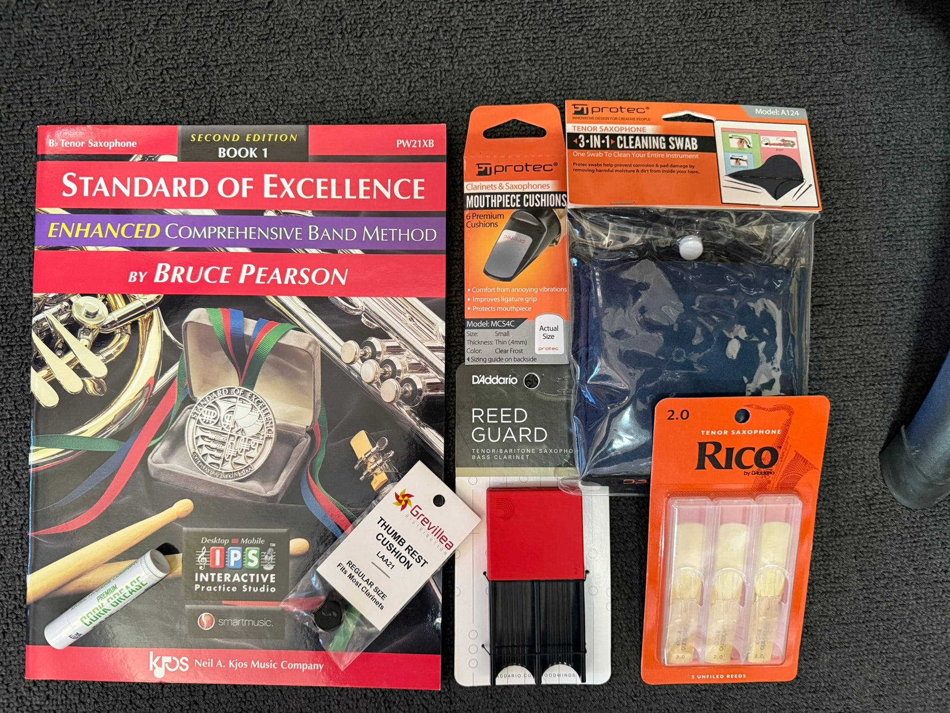 Tenor saxophone student bundle with book, reeds, reed guard, grease, cushions, and swab.