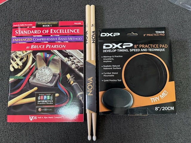 Drummer's bundle with "Standard of Excellence" book, drumsticks, and DXP practice pad.